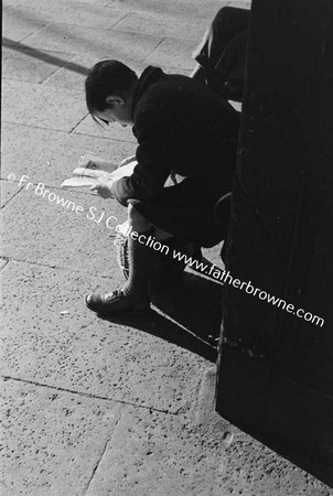 BOY READING AT STATION